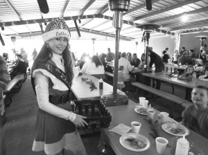 Sophomore Queen Catherine Duncan cleans up around the breakfast area, fulfilling her community service duties as a Queen’s court member.