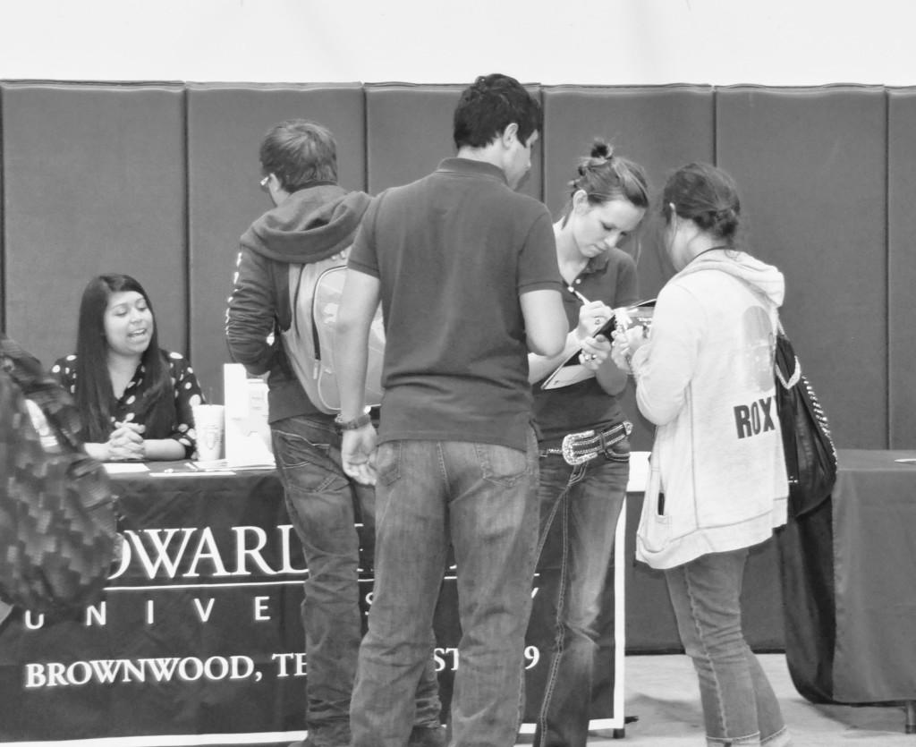 Junior Harley Shoemake fills out college information during the college fair.