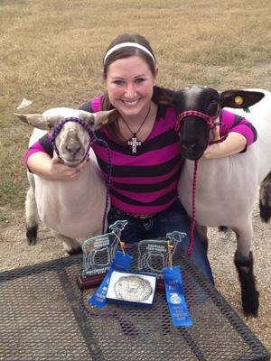 Senior Kelly Kaminski takes a picture  with her lambs after winning first place in the 2012 Hondo FFA Prospect Show.