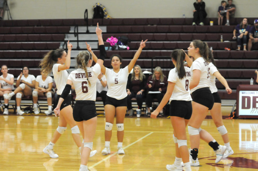 The Varsity team celebrates after they win a point.