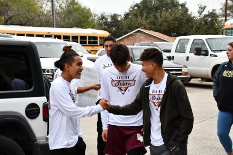 Cross Country team members pumping each other up during a DHS Wake Up Call.