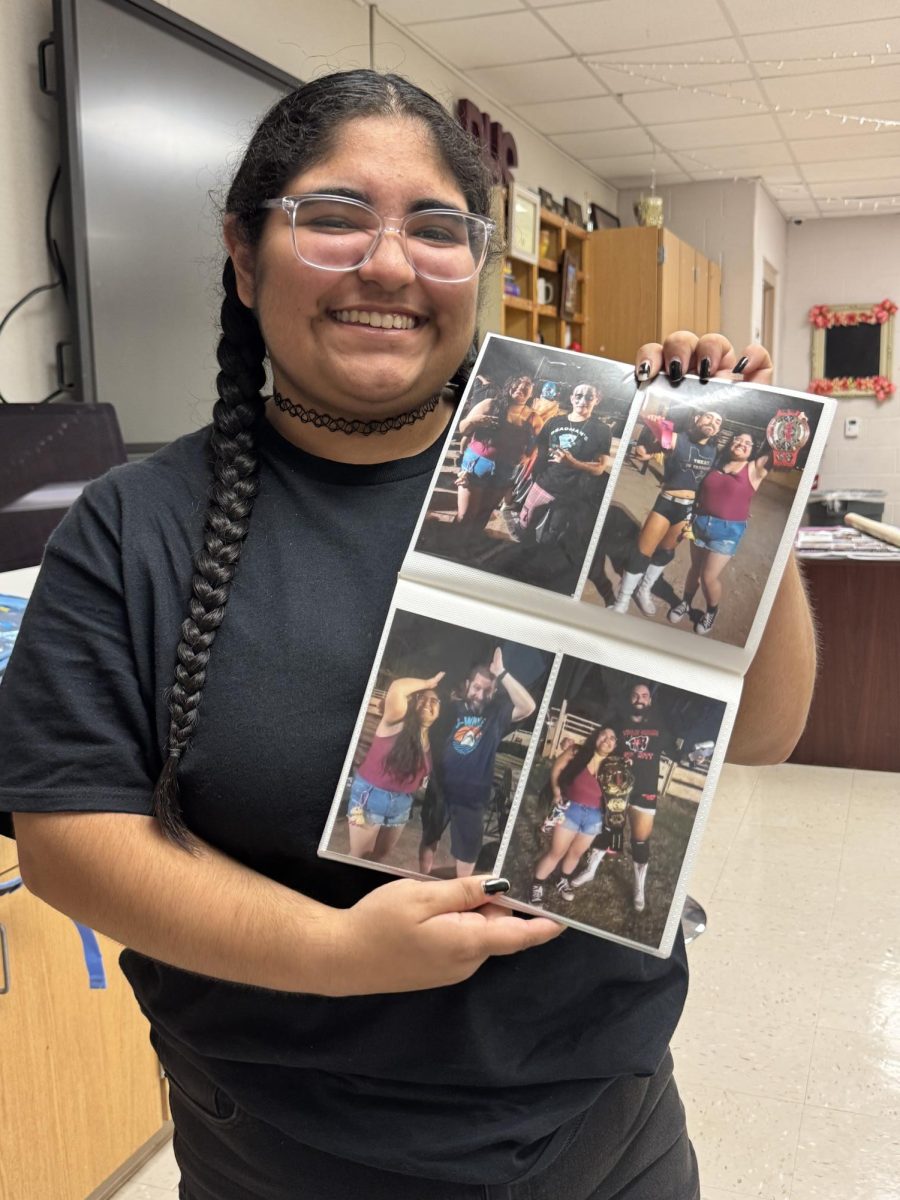 Senior Angel Marie Mason shares a look into her wrestling scrapbook, a collection of photos and memorabilia she has kept since her toddler years. The scrapbook highlights her early connection to the sport, including photos with wrestlers who have since advanced to World Wrestling Entertainment.