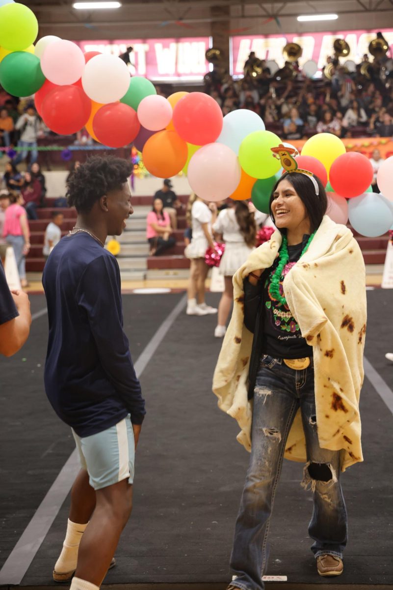 Marisol Custodio Robledo and Ray'Sean Beaver joke as they prepare for their roles in the Fiesta themed pep rally that doubles as a kick off to Hispanic Heritage Month.