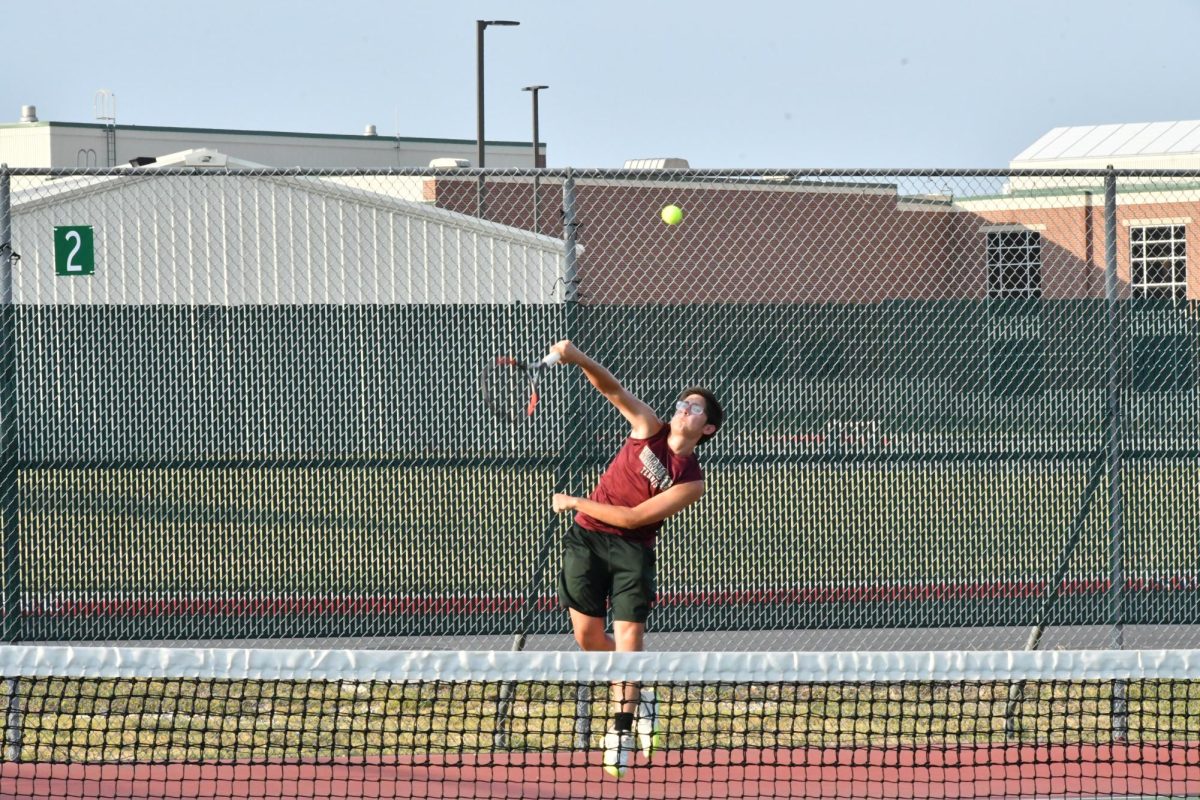 Senior Bryson Robison begins play during a September Devine varsity team match.