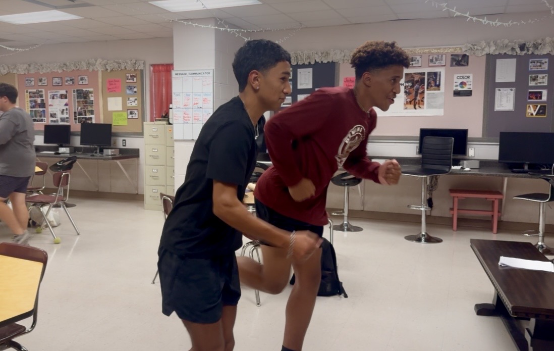 Multi Media Journalists Shawn Lowe and Christian Beaver practice the closing to the cross country regional update Thursday.